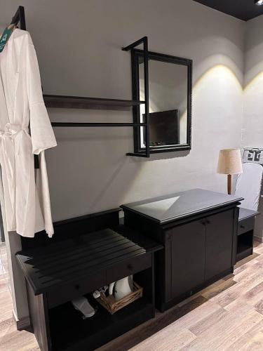 a dressing room with a table and a mirror at Swing & Pillows - KLIA 1 KLIA 2, Sepang in Sepang