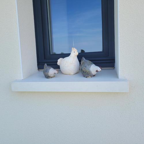 a group of figurines sitting on a window sill at Pause 24 in Saint-Laurent-des-Vignes