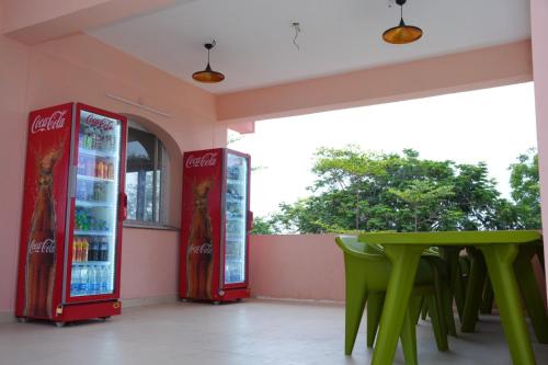 a restaurant with a green table and vending machines at Haritha Beach Resort Kothakoduru in Nellore
