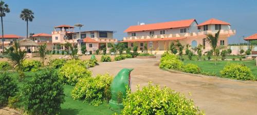 a green statue in front of a building at Haritha Beach Resort Kothakoduru in Nellore