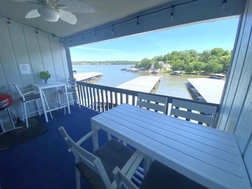 a balcony with a table and chairs and a view of the water at B Lakefront! Remodeled, Boat Slip, Patio Views, Pool, Boat Ramp, WIFI in Osage Beach