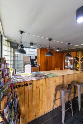 a store with a counter with two chairs in a room at Chang Chang Hostel in Chiang Mai