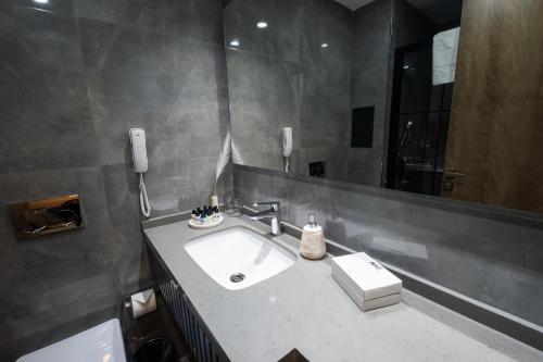 a bathroom with a sink and a mirror at Buke Hotel Bomonti in Istanbul
