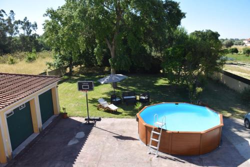 a hot tub in a yard next to a house at GuestReady - Quinta do Sol in Mealhada