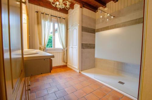 a bathroom with a shower with a sink and a mirror at La mylardiere in Piney