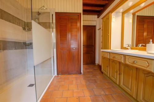 a bathroom with a shower and a sink at La mylardiere in Piney