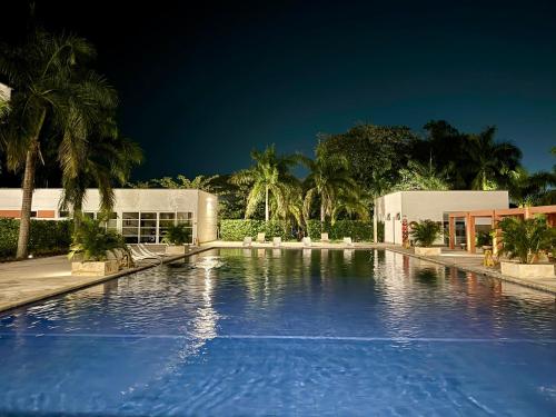 a large swimming pool in front of a building at Hotel Morúa in Yopal