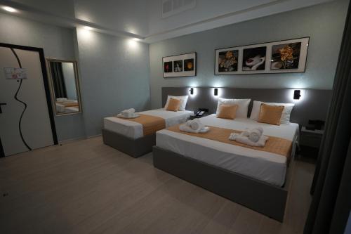 a bedroom with two beds with towels on them at OLD BaTuMi in Batumi