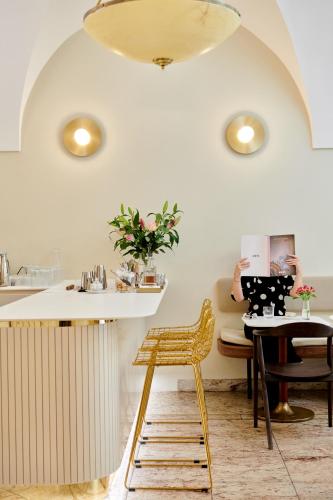 a kitchen with a table and a yellow chair at Hotel Nerudova 211 in Prague
