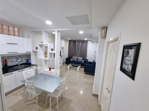 a kitchen and living room with a table and chairs at Hydra Résidence Privée in Hydra