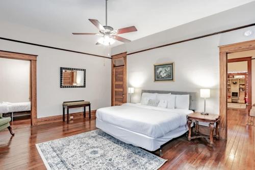 a bedroom with a white bed and a ceiling fan at Heavenly on Hunter-Historic Grandeur-The Cannon in Mobile