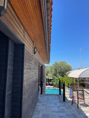 a walkway leading to the side of a house with a pool at Ata Boutique Hotel in Altınyunus