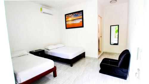 Hotel Vias Maya Bacalar tesisinde bir odada yatak veya yataklar