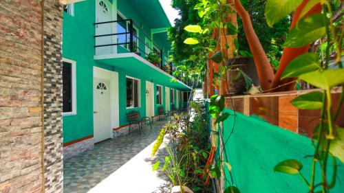 a building with a green and white facade at Hotel Vias Maya Bacalar in Bacalar