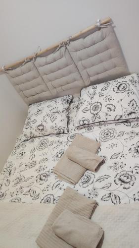 a bed with a black and white comforter and pillows at Apartament CullerA in Cullera