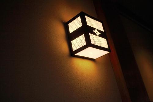a light on the side of a wall at Ryokan Wataya in Karatsu