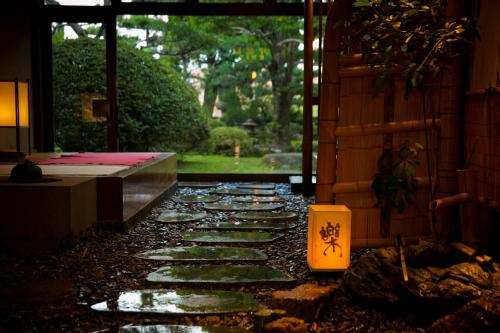 a stone walkway in a building with a window at Ryokan Wataya in Karatsu