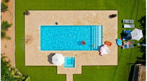 an overhead view of a swimming pool with a beach at Villa Can Blai in Santa Eularia des Riu