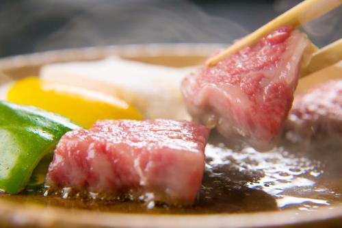 a plate of food with meat and other foods at Ryokan Wataya in Karatsu