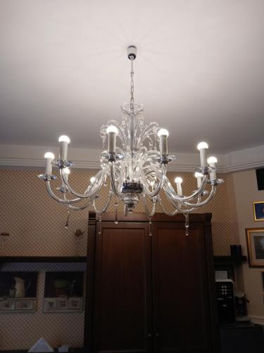 a chandelier is hanging from a ceiling at La Suite del Vulcano in Belpasso
