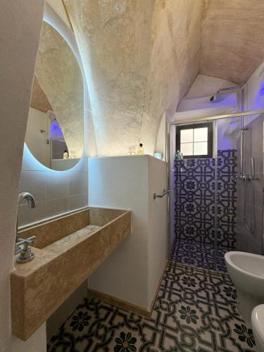 a bathroom with a large tub and a sink at Il Pozzo Antico in Gallipoli