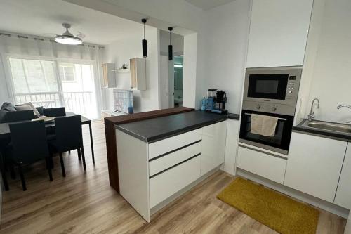 a kitchen with a counter top and a kitchen with a table at Apartment in the center of Fuengirola in Fuengirola