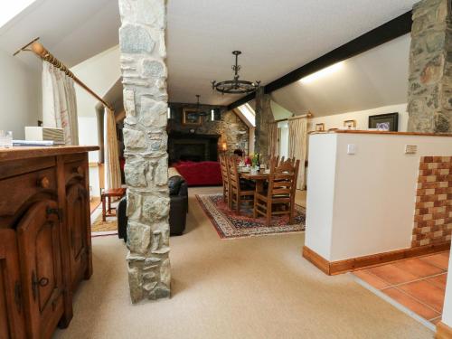 a kitchen and living room with a refrigerator and a table at The Steading in Dalmally