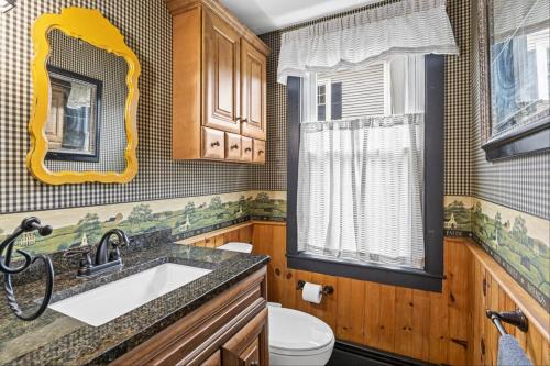 a bathroom with a sink and a mirror at Downtown Plymouth Gem in Plymouth