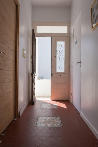 an empty hallway with a door and a window at CASA MONICA CARGESE - Roseroom - Chambre d hote in Cargèse