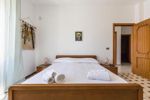 a bedroom with a bed with towels on it at Villa Bea by BarbarHouse in Taranto