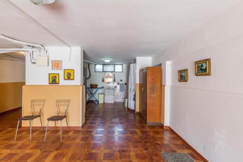 a hallway with two chairs and a counter in a room at Villa Bea by BarbarHouse in Taranto