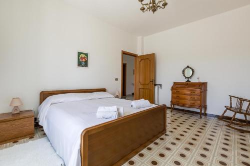 a bedroom with a large bed with towels on it at Villa Bea by BarbarHouse in Taranto