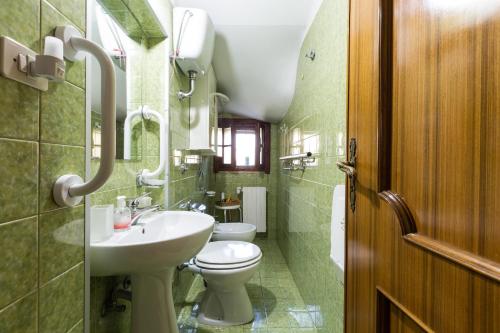 a bathroom with a sink and a toilet and a mirror at Villa Bea by BarbarHouse in Taranto