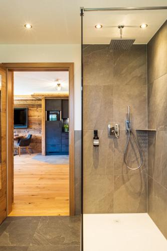 a bathroom with a shower with a glass door at Appartements Hochödlehen in Schönau am Königssee