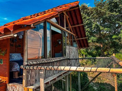 a cabin with glass doors and a roof at La Julita Glamping in La Mesa