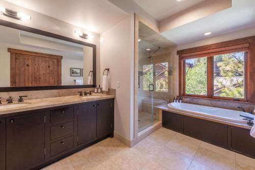 a bathroom with a sink and a tub and a window at Luxury Northstar Home Walk to Lifts Private Hot-Tub Fenced-In Yard Book on Mobile for Promo Price in Truckee
