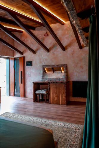 a bedroom with a desk and a mirror on the wall at Hotel Thethi in Theth