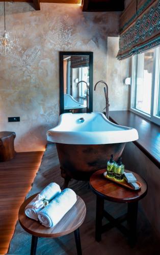 a bathroom with a large sink and a mirror at Hotel Thethi in Theth