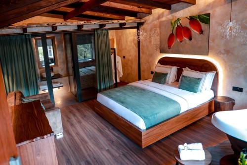 a bedroom with a large bed and a bathroom at Hotel Thethi in Theth