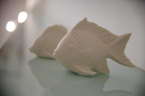 a toy fish sitting on top of a table at Donna Adriana Rooms in Agropoli