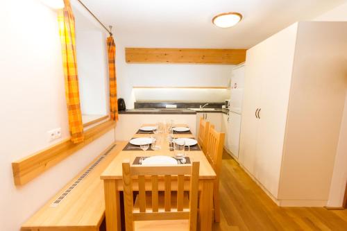 a kitchen with a long wooden table and chairs at Bedřichovská Devítka in Bedřichov