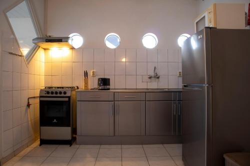 a kitchen with a refrigerator and a stove top oven at Sabajo appartement verhuur in Paramaribo