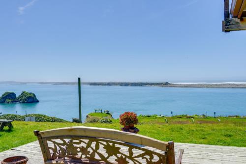 a bench sitting on a deck with a view of the water at Smith River Home with Boat Launch and Ocean Views in Smith River