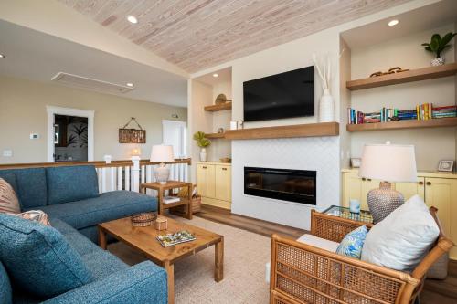 a living room with a blue couch and a fireplace at All Sands On Deck in Oak Island