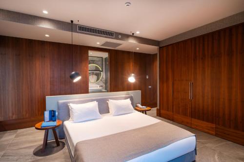 a bedroom with a large bed and wooden cabinets at Arts Hotel Bodrum Yalikavak in Yalıkavak