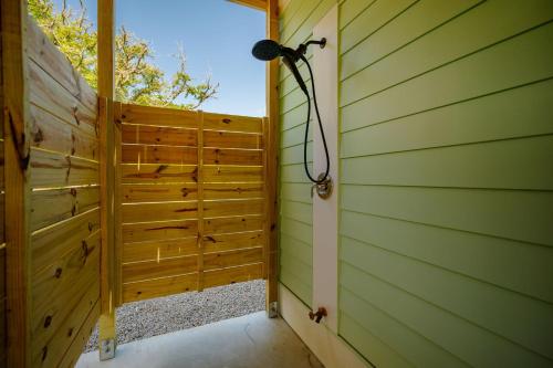a room with a shower in the side of a house at All Sands On Deck in Oak Island