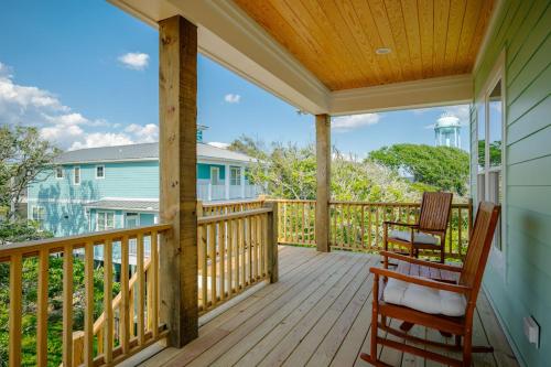 a porch with two chairs and a water tower at All Sands On Deck in Oak Island