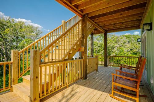a wooden deck with a bench and a wooden staircase at All Sands On Deck in Oak Island