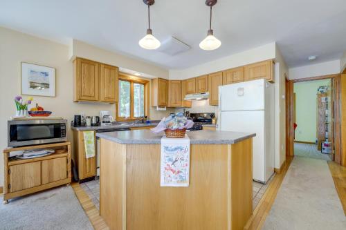 a kitchen with wooden cabinets and a white refrigerator at Serene Steuben Home with Scenic Ocean Views! in Steuben
