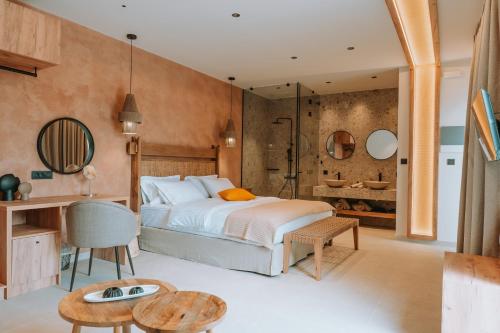 a bedroom with a large bed and a bathroom at Gabbana Beach Villas in Syvota